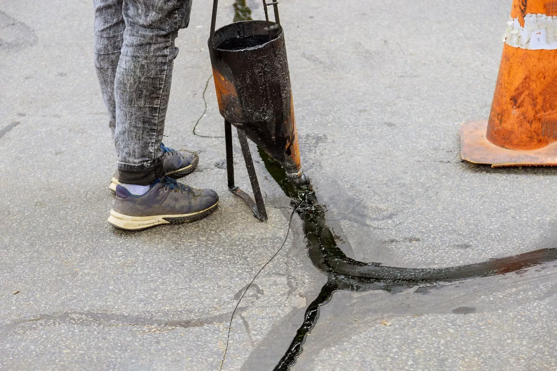 Close-up of asphalt surface with visible cracks